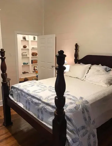 a bed sitting in a bedroom and dresser