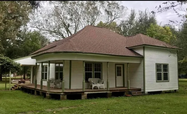a front view of house with yard and green space