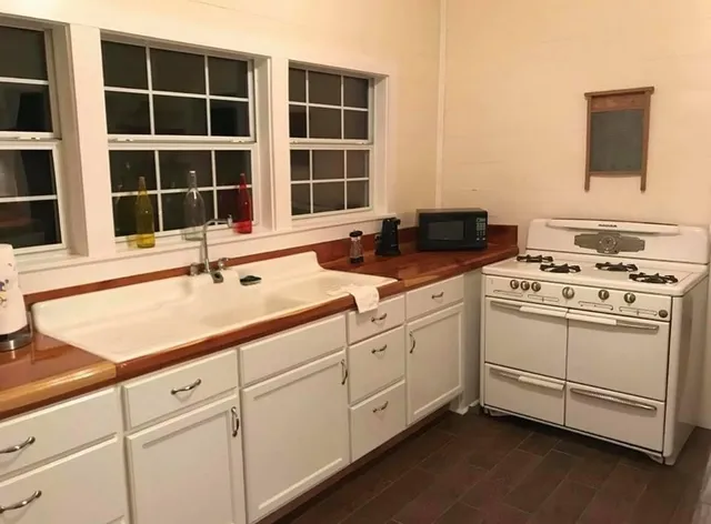 a kitchen with appliances cabinets and a sink