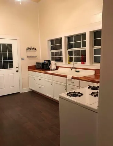 a kitchen that has a sink and a stove