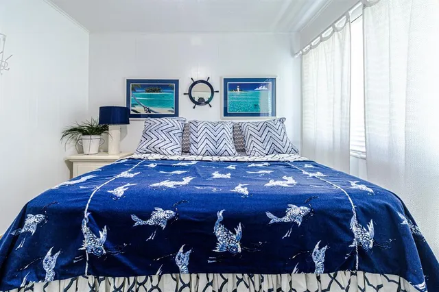 a bedroom with a bed and a lamp