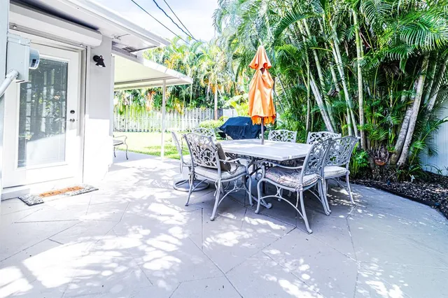 a view of a backyard with a patio and outdoor seating