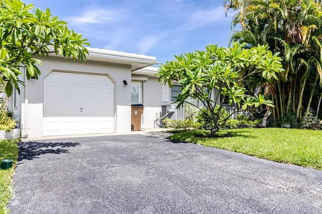 a front view of a house with a yard and a garage