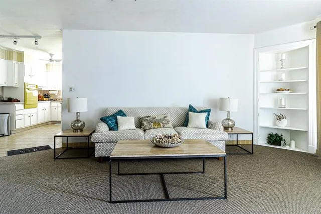 a living room with furniture and a lamp