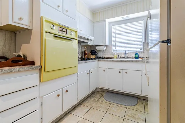 a utility room with cabinets washer and dryer