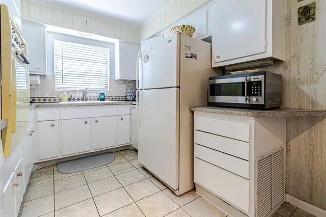 a kitchen with stainless steel appliances a refrigerator sink and microwave