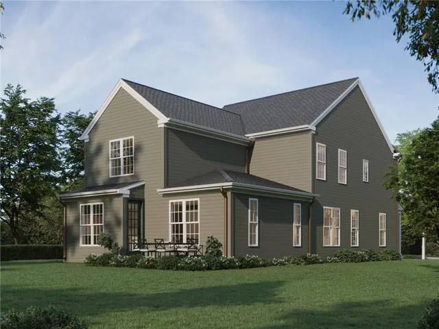 a front view of a house with a yard and trees