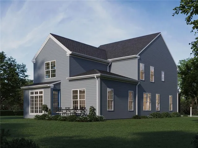 a front view of a house with a yard and trees