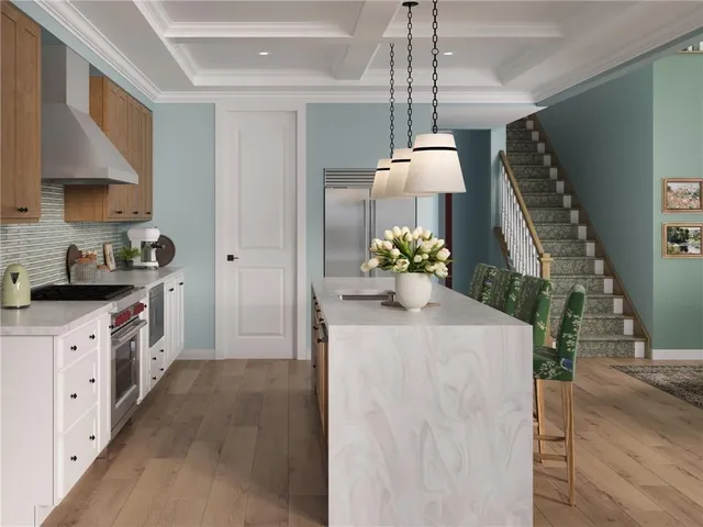 a kitchen with stainless steel appliances granite countertop a sink a stove and a wooden floors