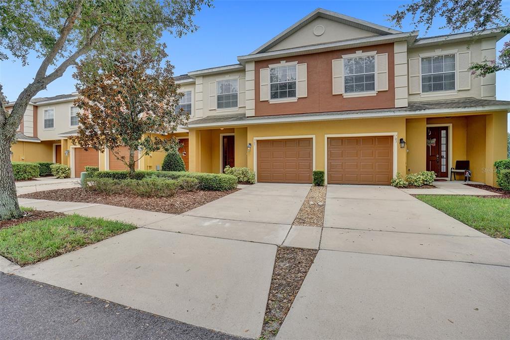 707 Marotta Loop Ocoee, FL 34761 - Photo 1 of 1 front view of a brick house with a yard