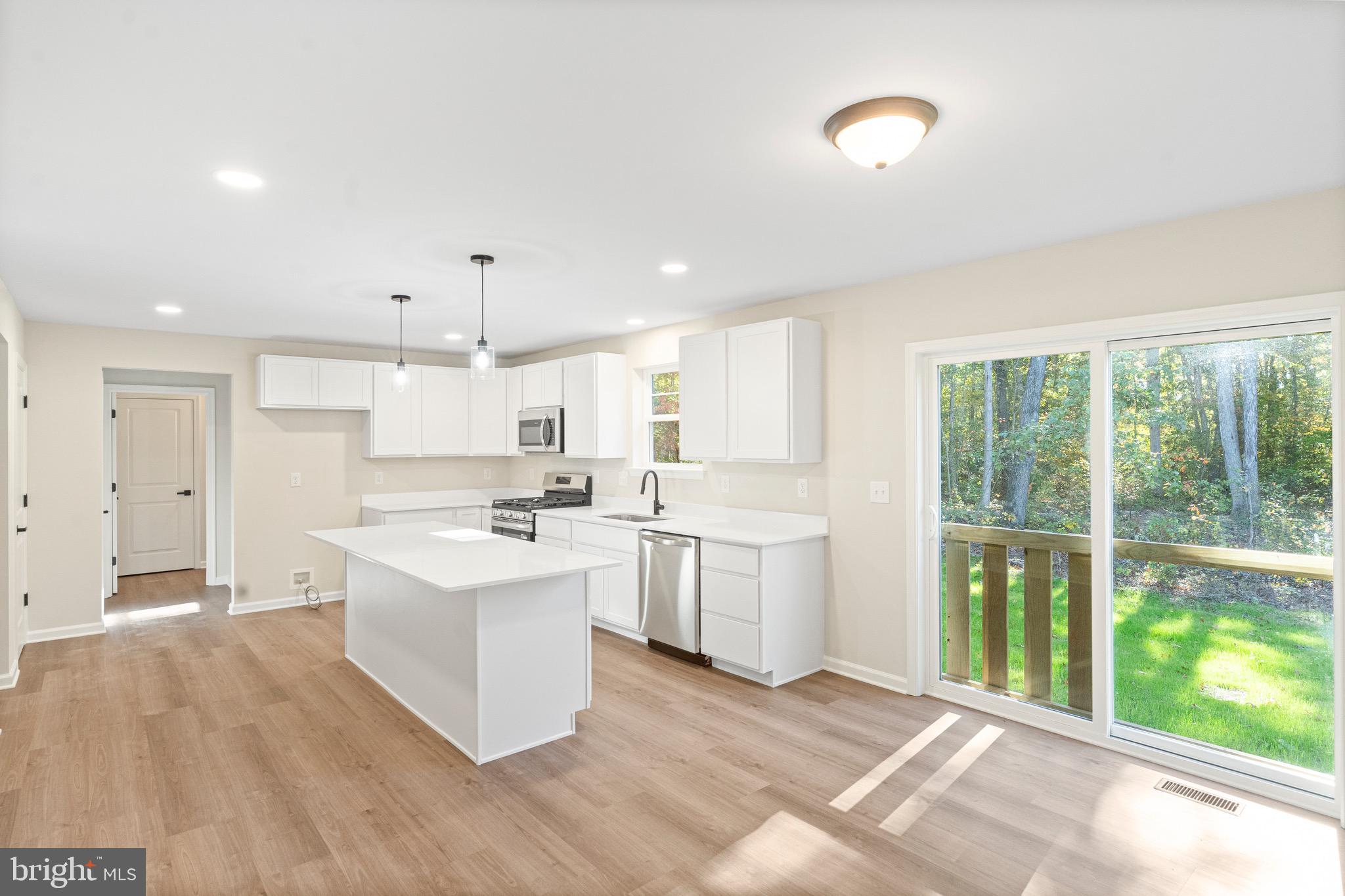 765 Little Mill Road Monroeville, NJ 08343 - Photo 11 of 39 a large white kitchen with a large window a sink and stainless steel appliances