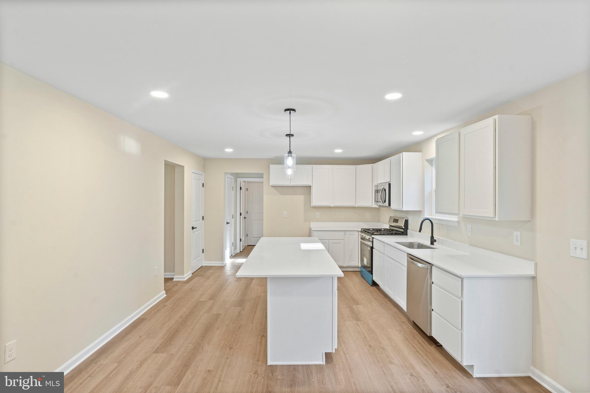765 Little Mill Road Monroeville, NJ 08343 - Photo 12 of 39 a large kitchen with stainless steel appliances granite countertop a sink dishwasher a stove and white cabinets with wooden floor