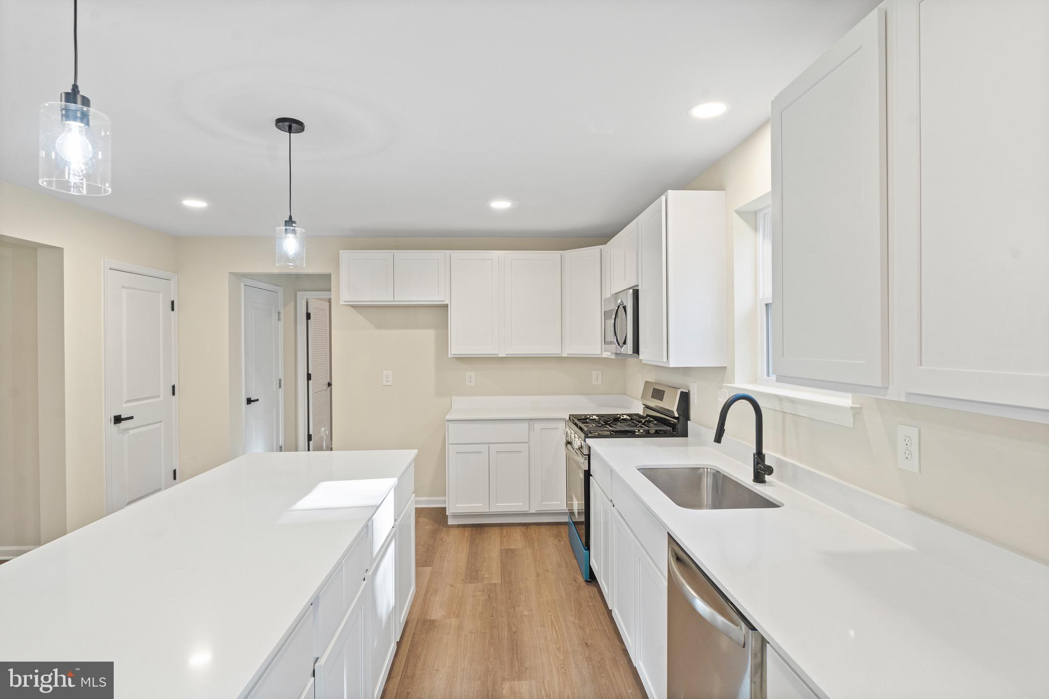 765 Little Mill Road Monroeville, NJ 08343 - Photo 14 of 39 a kitchen with a sink a stove a refrigerator and cabinets