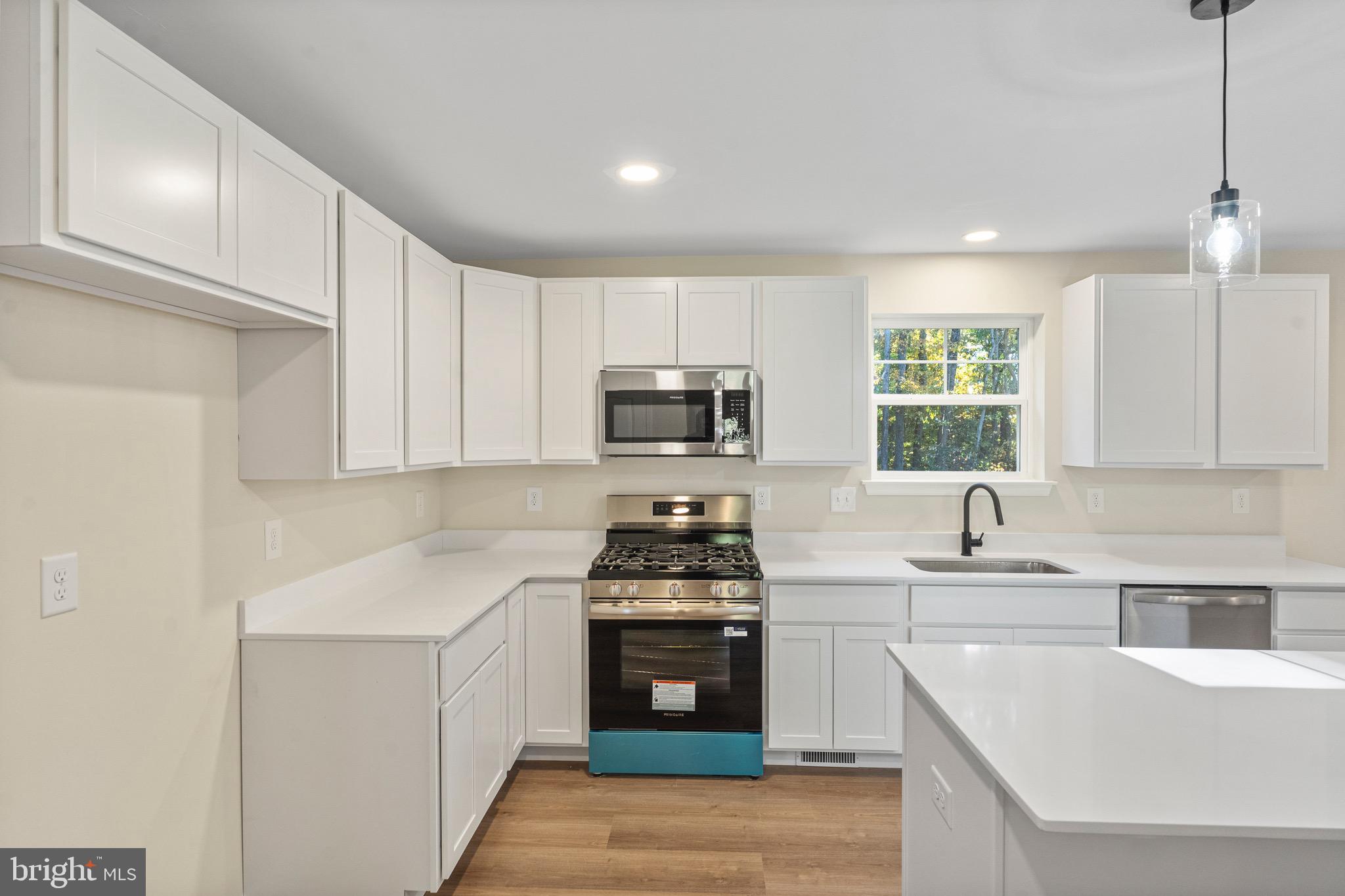 765 Little Mill Road Monroeville, NJ 08343 - Photo 16 of 39 a kitchen with stainless steel appliances a stove sink microwave and cabinets