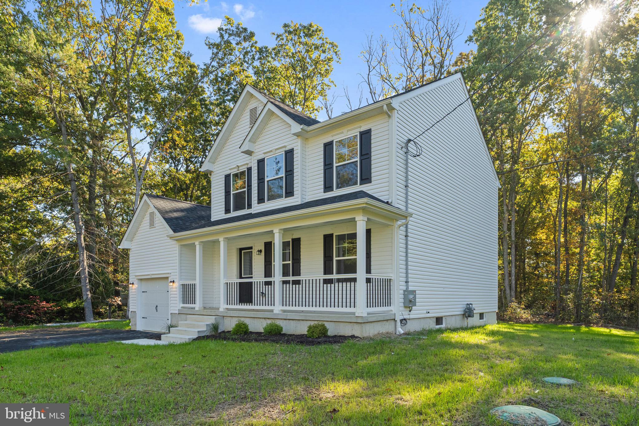 765 Little Mill Road Monroeville, NJ 08343 - Photo 3 of 39 a front view of a house with a yard and trees