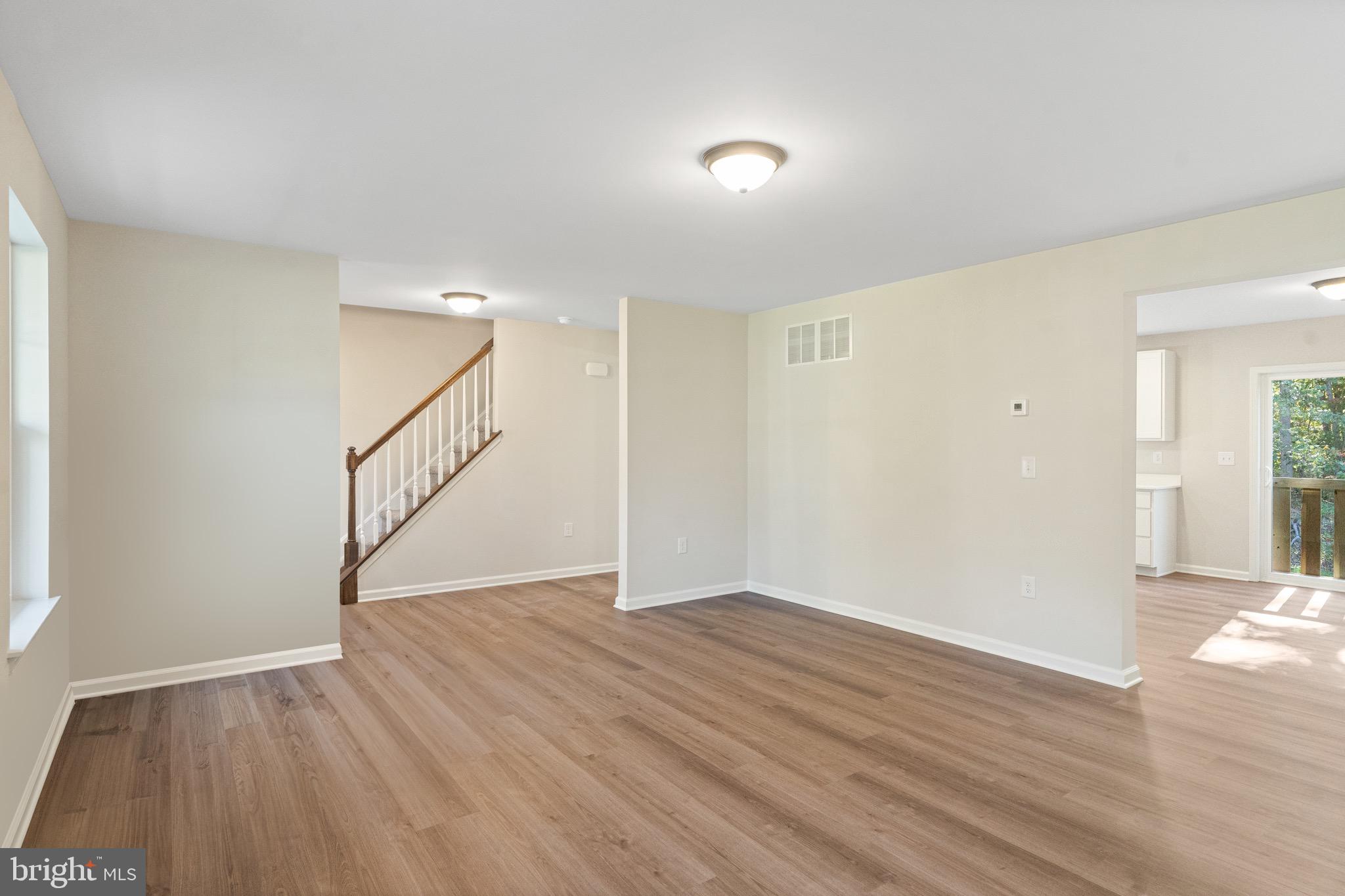 765 Little Mill Road Monroeville, NJ 08343 - Photo 10 of 39 a view of an empty room with wooden floor and stairs