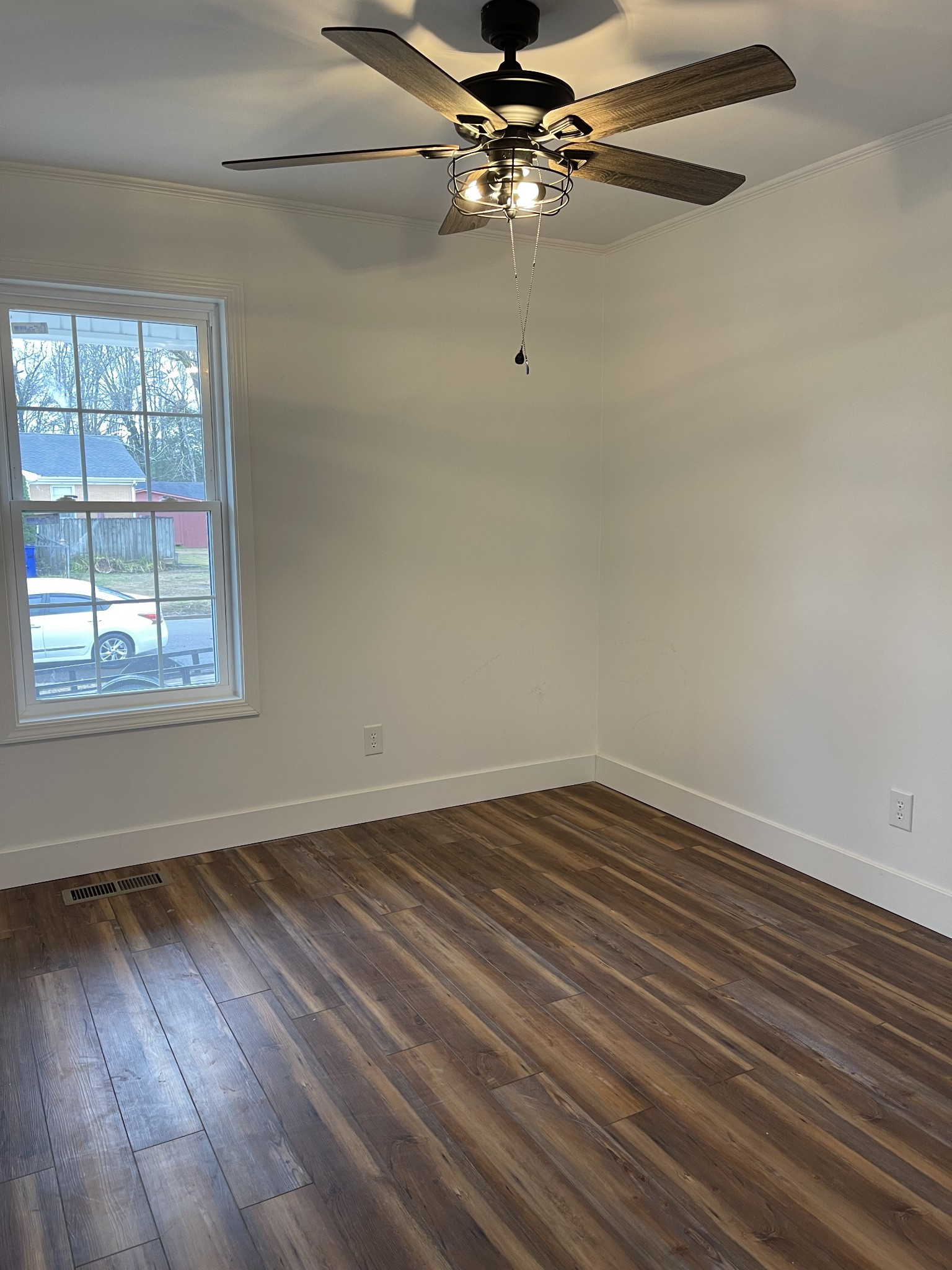 255 Maple Street Savannah, TN 38372 - Photo 12 of 20 wooden floor in an empty room with a window
