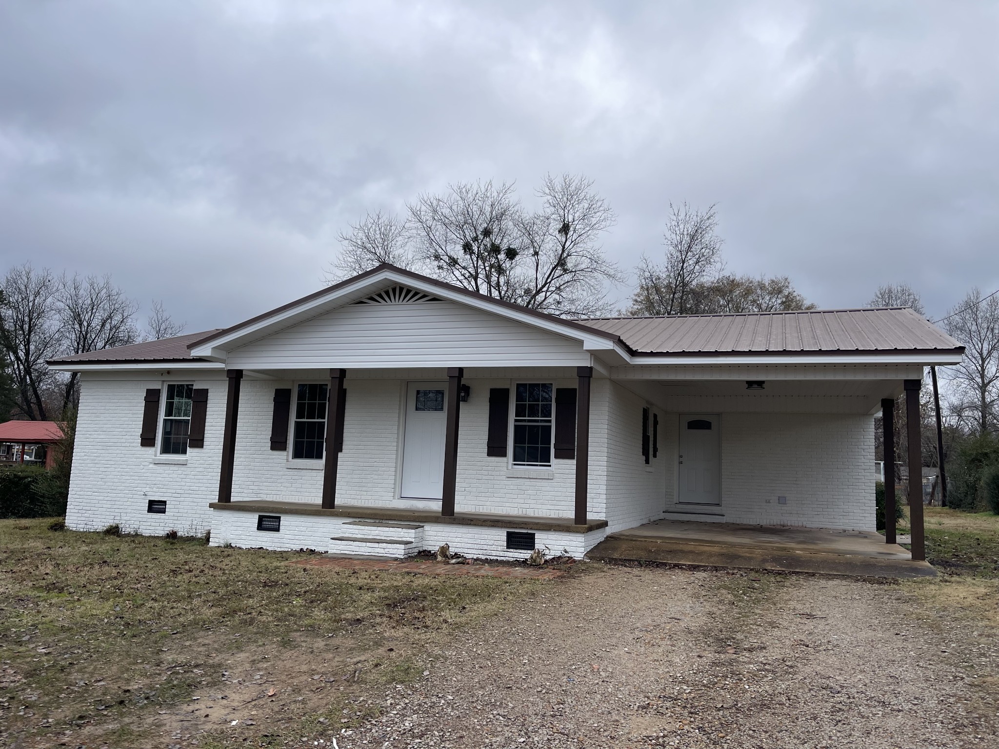 255 Maple Street Savannah, TN 38372 - Photo 2 of 20 a house with trees in the background