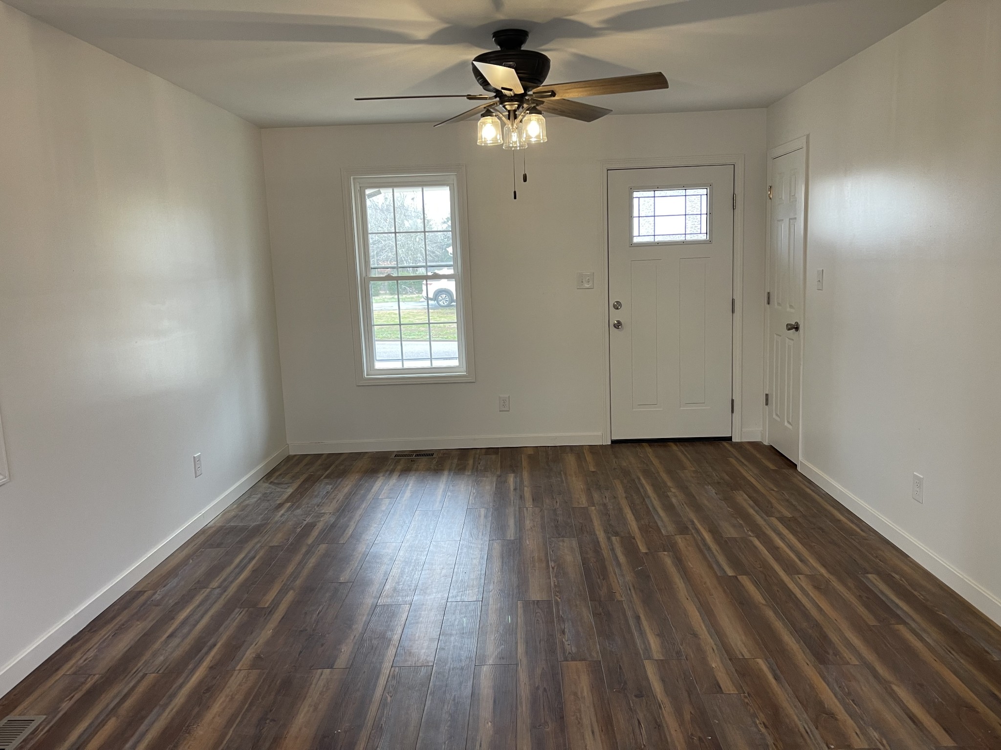 255 Maple Street Savannah, TN 38372 - Photo 6 of 20 wooden floor in an empty room with a window