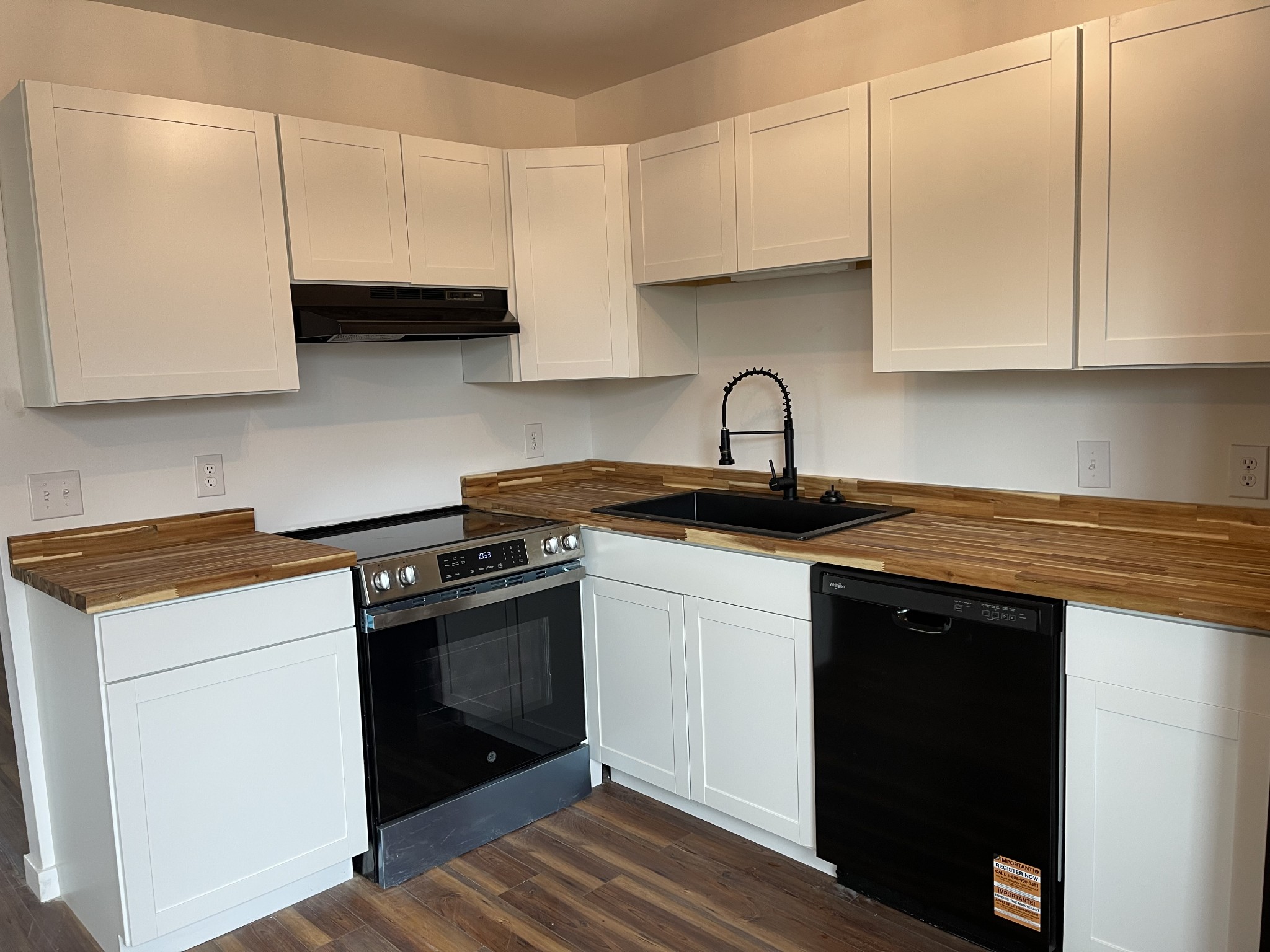 255 Maple Street Savannah, TN 38372 - Photo 7 of 20 a kitchen with granite countertop white cabinets and black appliances