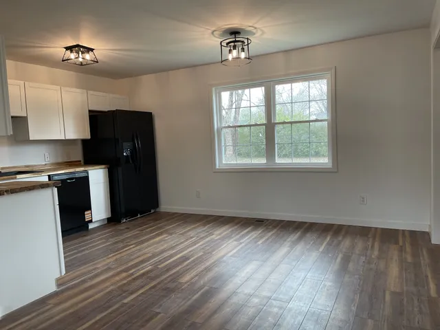a kitchen with a stove top oven and refrigerator