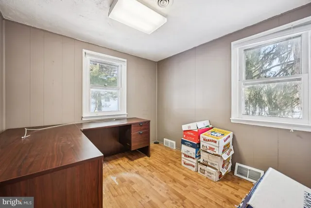 a living room with a bed and a window