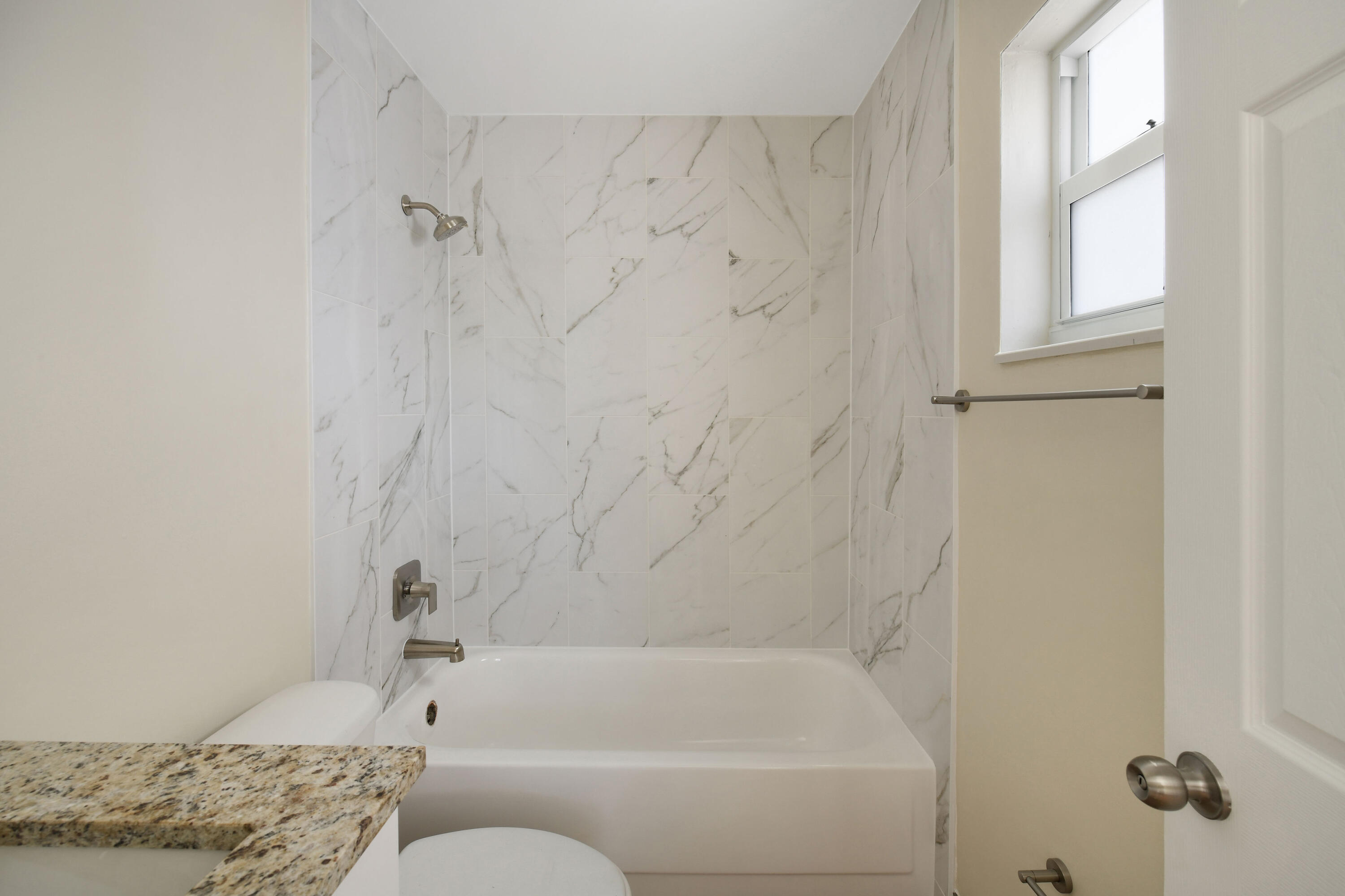 901 North F Street, Unit 8 Lake Worth Beach, FL 33460 - Photo 11 of 15 a bathroom with a tub and shower