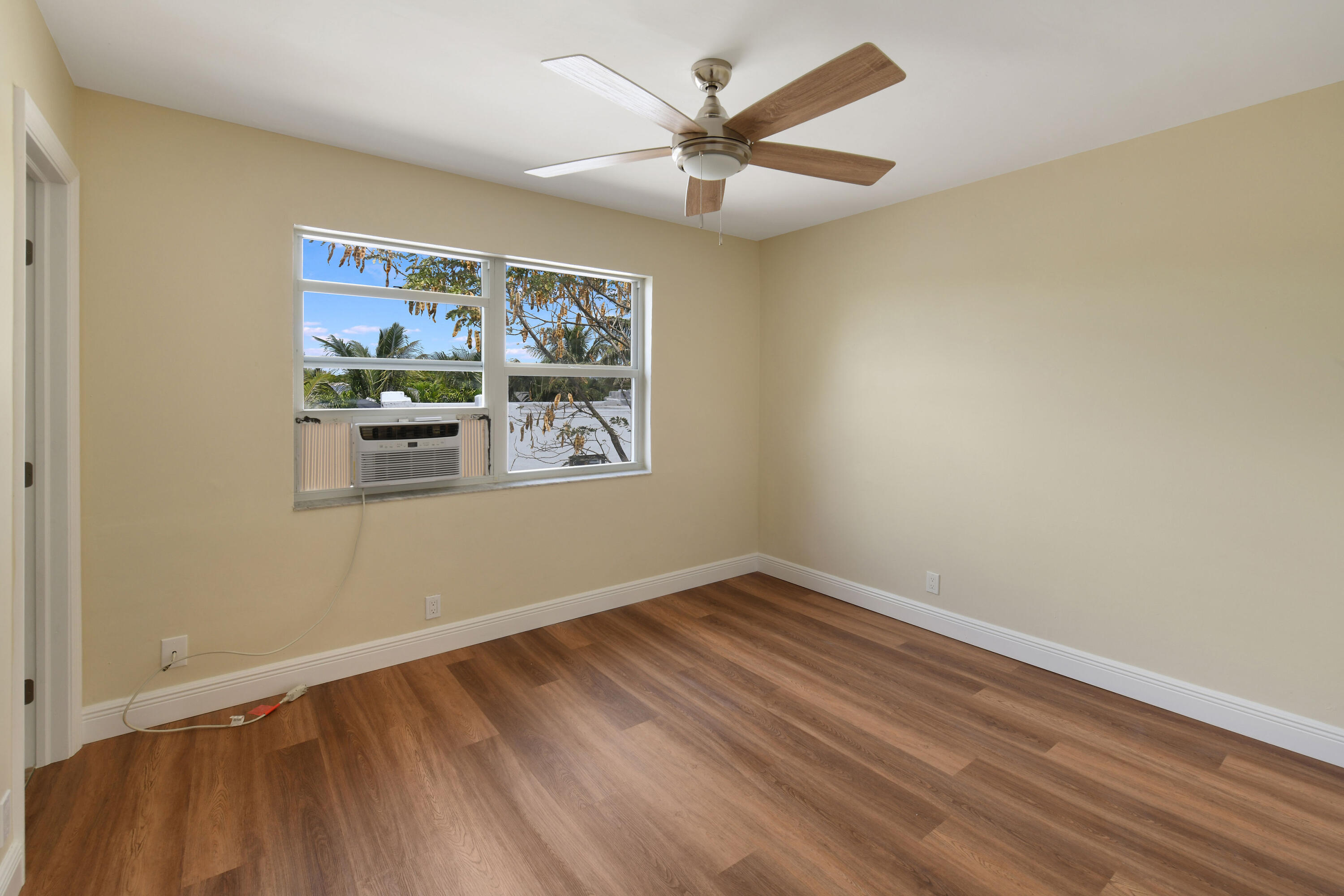 901 North F Street, Unit 8 Lake Worth Beach, FL 33460 - Photo 13 of 15 a view of a room with wooden floor and ceiling fan