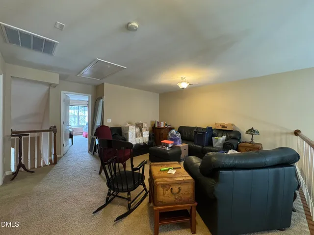 a living room with furniture and a dining table with projector the view