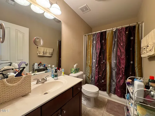 a bathroom with a sink mirror and toilet