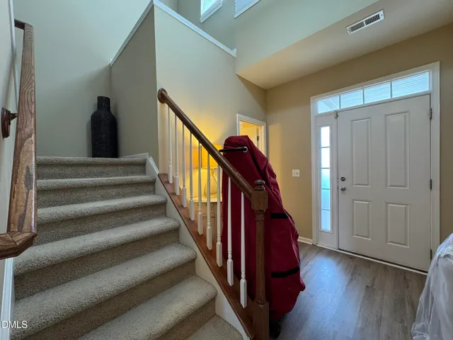 a view of a hallway to an entryway and wooden floor