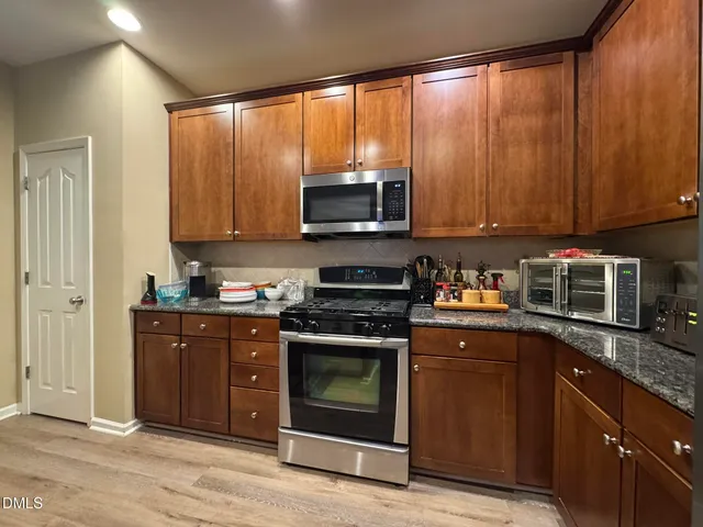 a kitchen with a stove a sink and a microwave