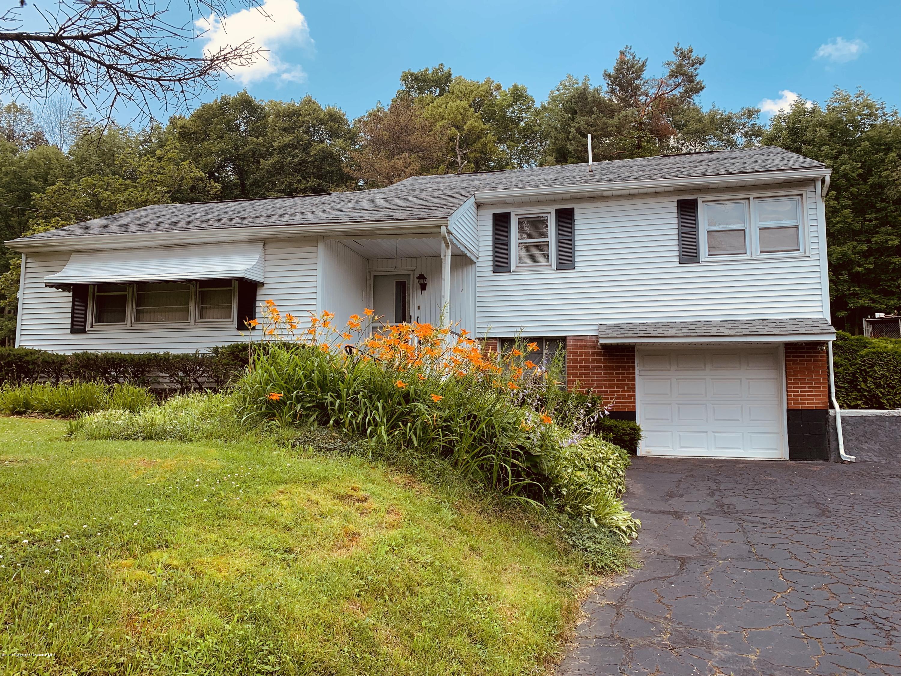 797 Cortez Road Lake Ariel, PA 18436 - Photo 1 of 15 a front view of house with yard and trees around