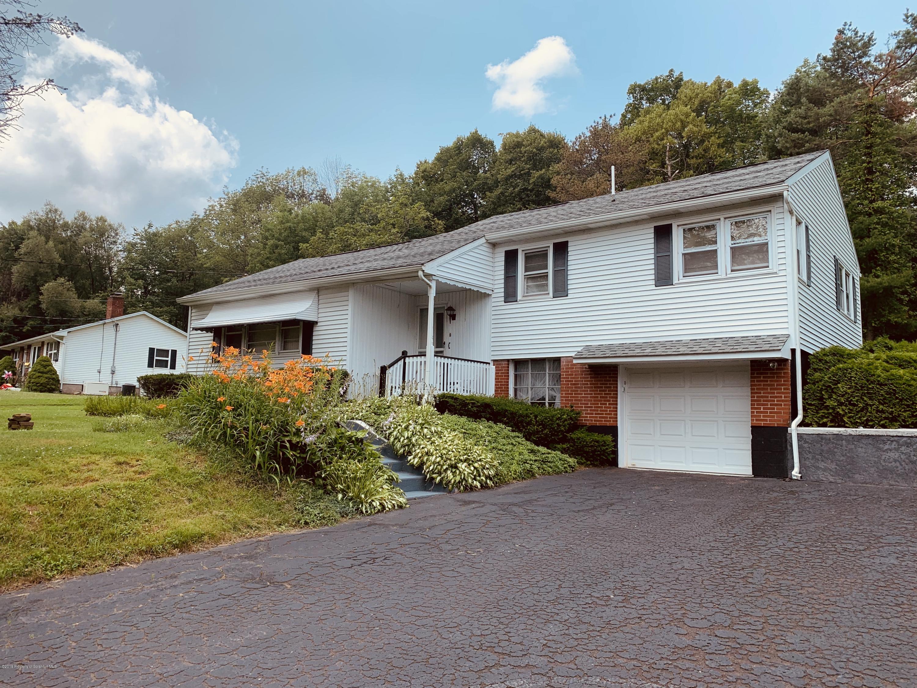 797 Cortez Road Lake Ariel, PA 18436 - Photo 2 of 15 a front view of house with yard and trees in the background