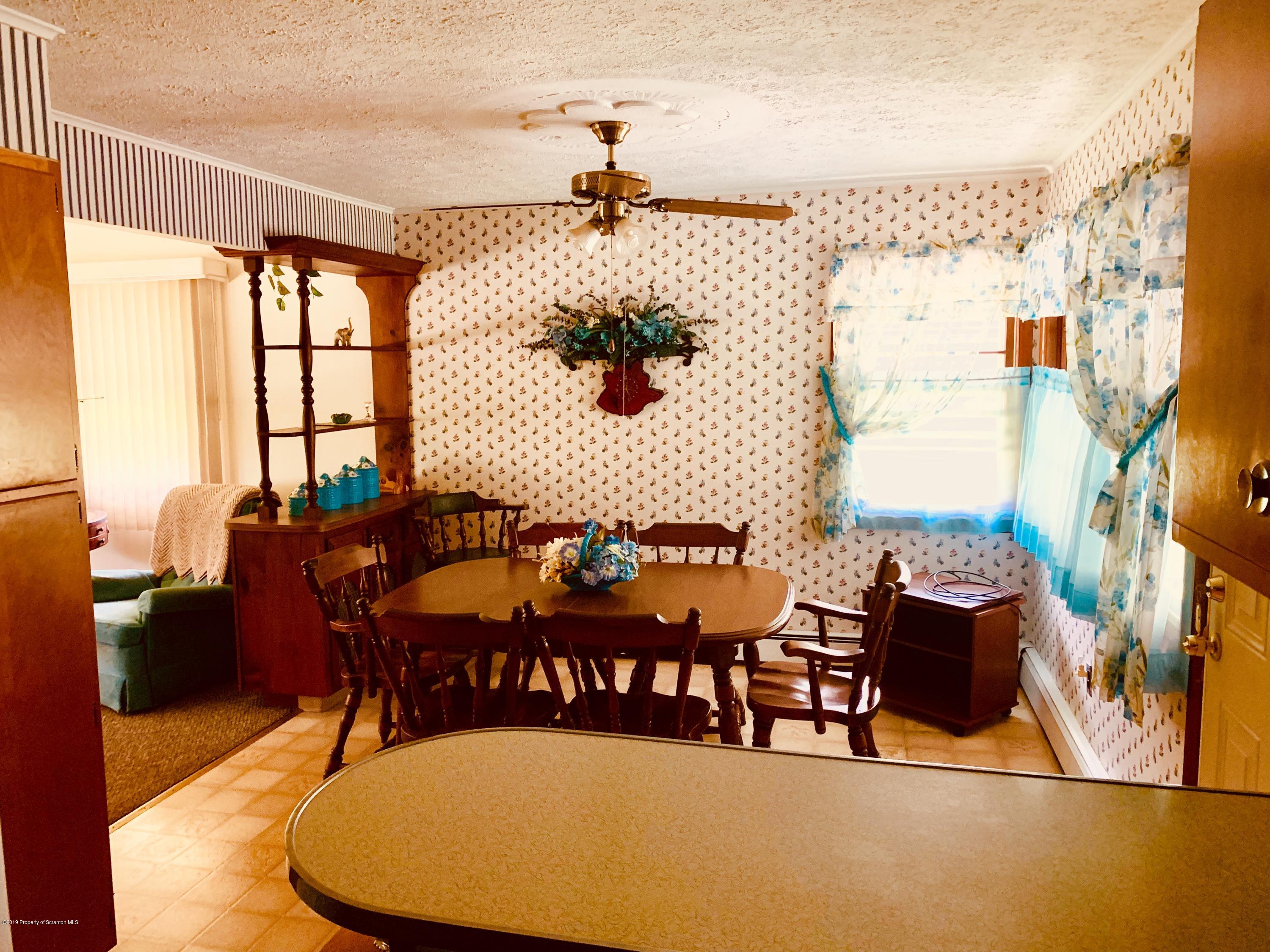 797 Cortez Road Lake Ariel, PA 18436 - Photo 7 of 15 a view of a dining room with furniture one side kitchen view and wooden floor