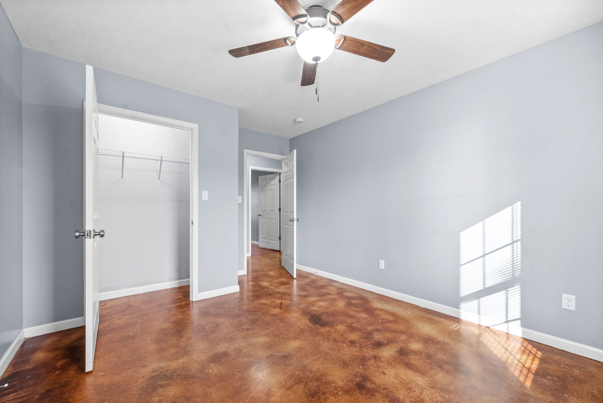113 Tinsley Drive Pembroke, KY 42266 - Photo 23 of 28 an empty room with chandelier fan and windows
