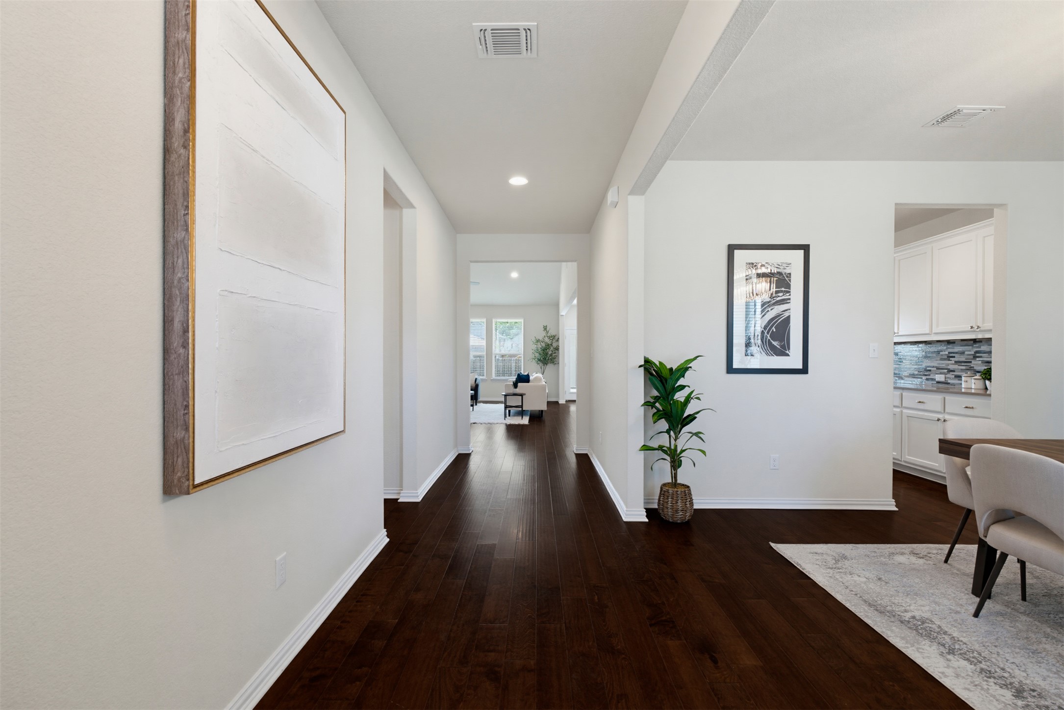 12613 Twisted Root Drive Manchaca, TX 78652 - Photo 27 of 33 Hardwood floors guide you through this inviting hallway, connecting open living spaces seamlessly.