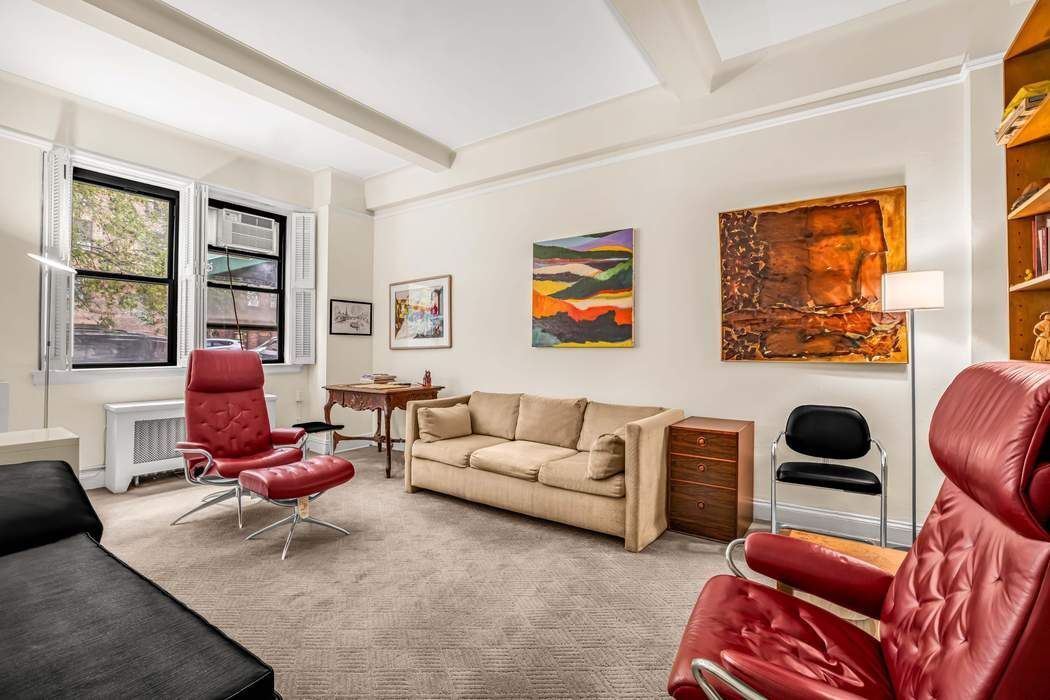 425 East 86th Street, Unit 1B/D Manhattan, NY 10028 - Photo 2 of 10 a living room with furniture or couch and a window
