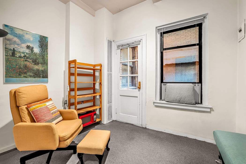 425 East 86th Street, Unit 1B/D Manhattan, NY 10028 - Photo 6 of 10 a living room with furniture and a window