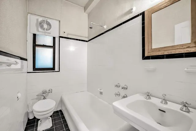 a bathroom with a sink a toilet and shower curtain