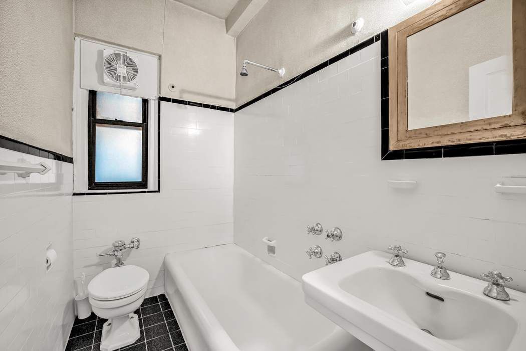 425 East 86th Street, Unit 1B/D Manhattan, NY 10028 - Photo 9 of 10 a bathroom with a sink toilet and mirror