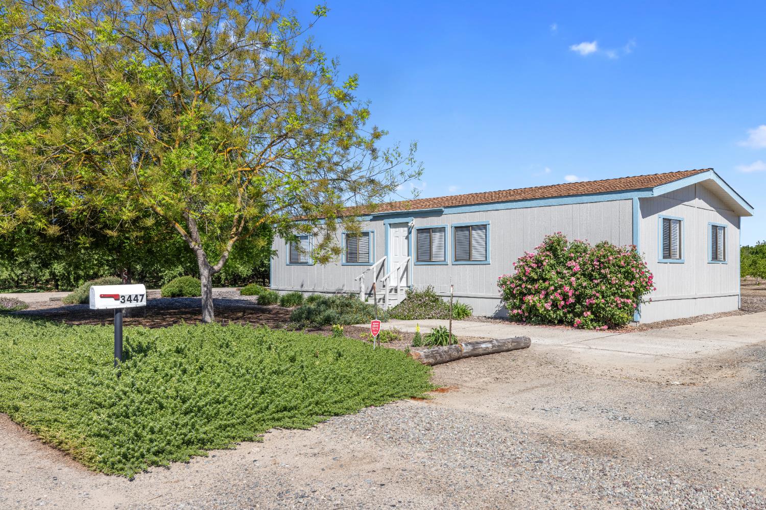 3443 Kansas Avenue Modesto, CA 95358 - Photo 20 of 45 a front view of a house with a yard and a garage