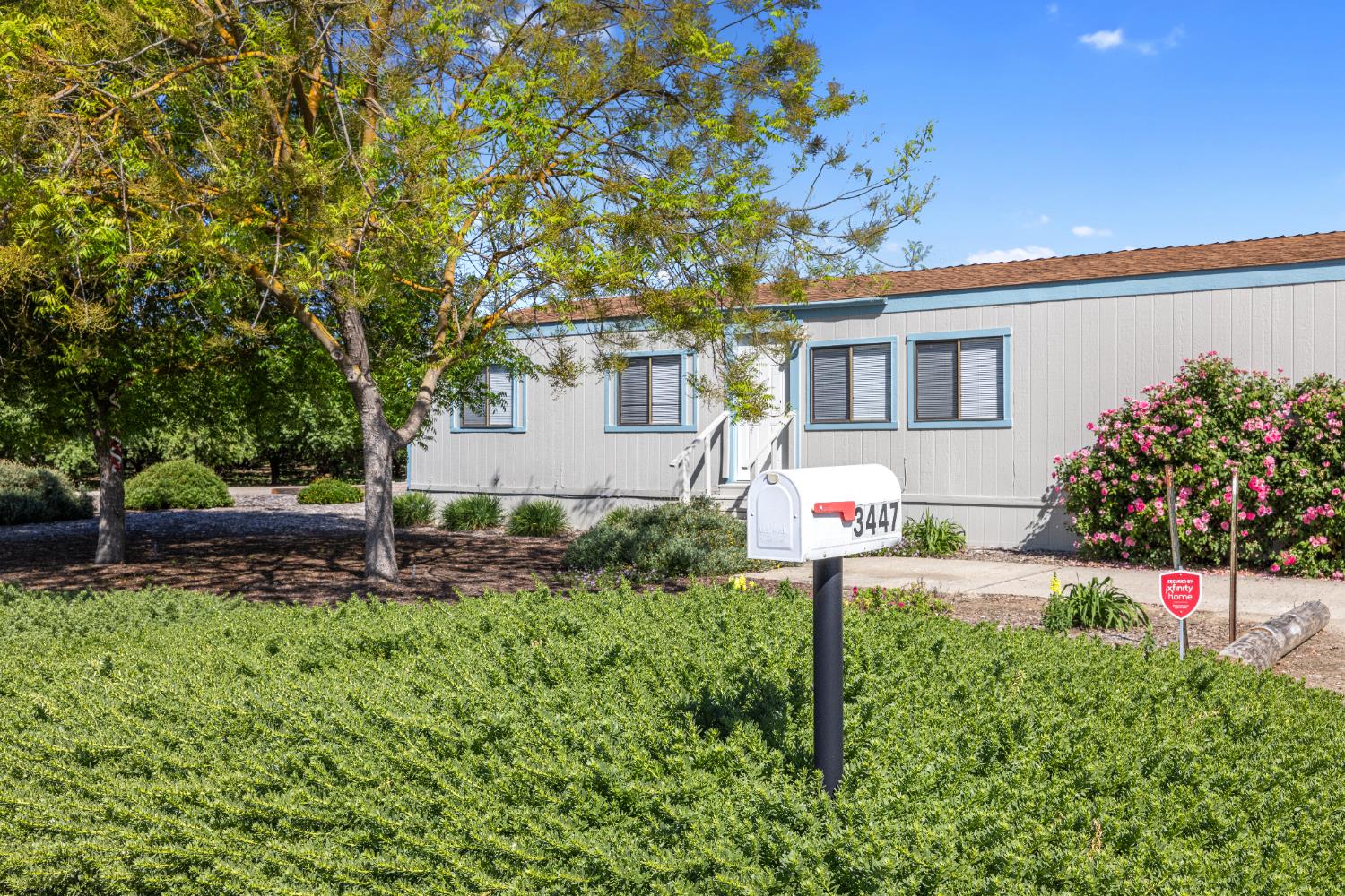 3443 Kansas Avenue Modesto, CA 95358 - Photo 21 of 45 a front view of a house with a yard and trees