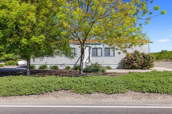 a front view of a house with a yard and a garage