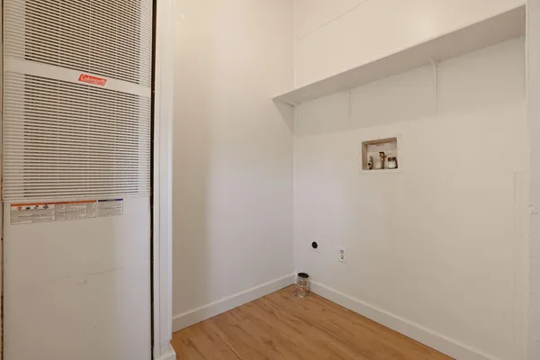 a view of a room with wooden floor