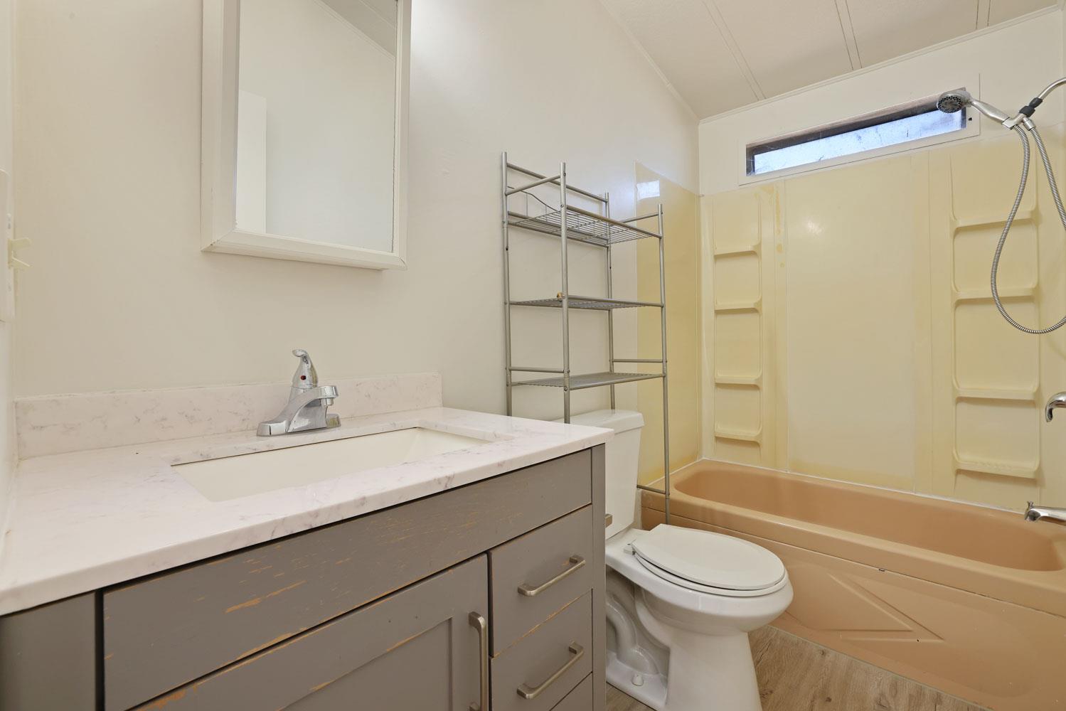 3443 Kansas Avenue Modesto, CA 95358 - Photo 33 of 45 a bathroom with a sink toilet vanity and shower