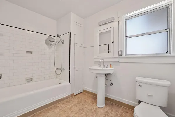 a bathroom with a sink toilet and shower