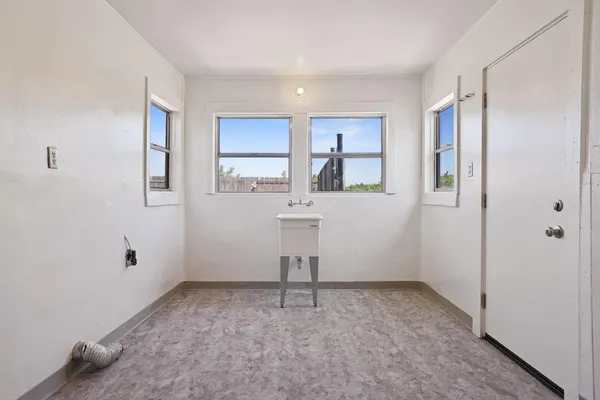 an empty room with windows and cabinet