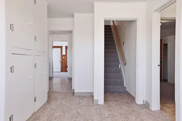 en view of a hallway with a room and stairs