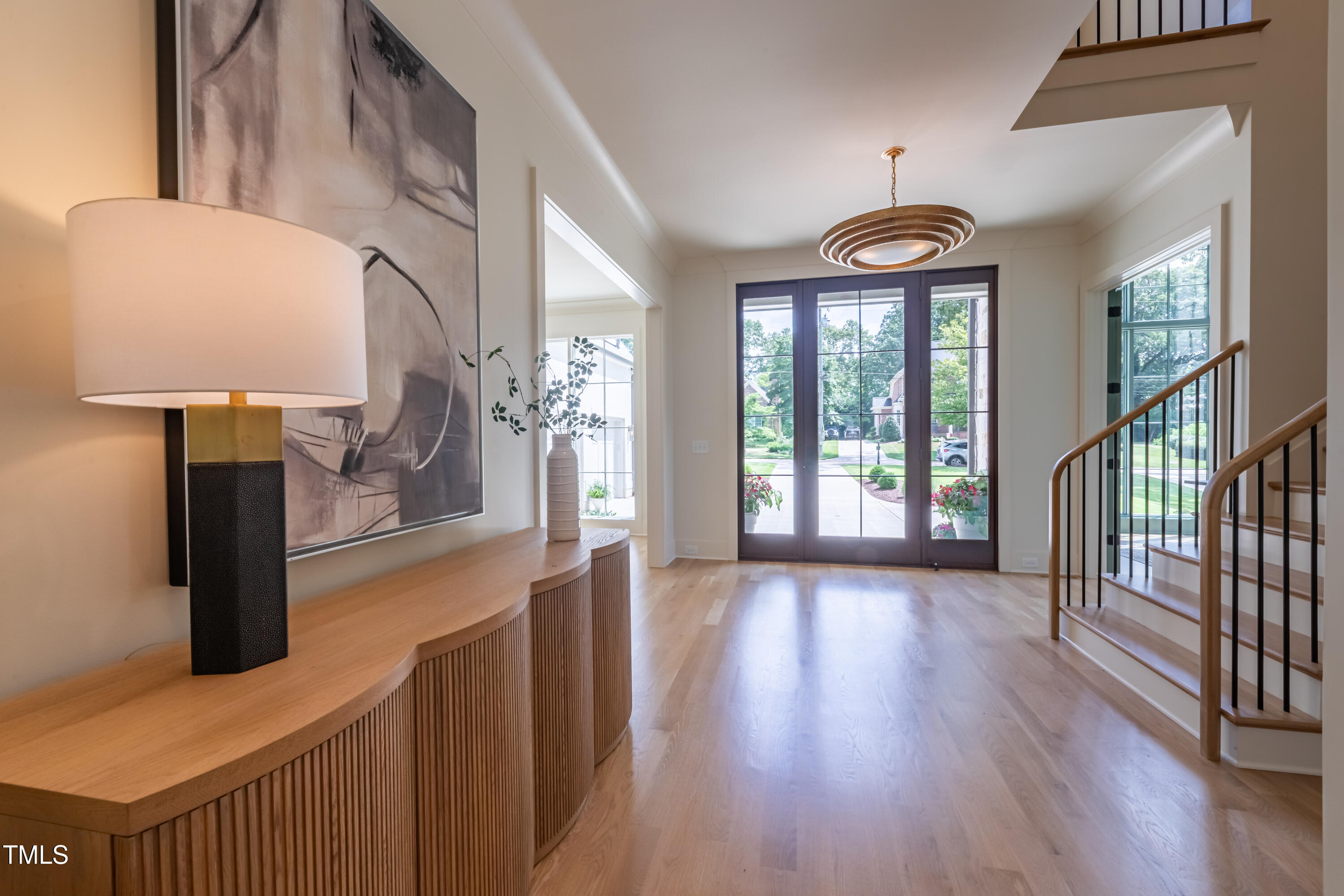 2227 Wheeler Road Raleigh, NC 27607 - Photo 10 of 56 a view of hallway with wooden floor and chandelier